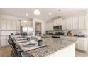 Island kitchen with granite countertops and stainless steel appliances at 554 Haven View Way, Murrells Inlet, SC 29576