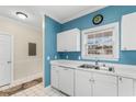 White kitchen cabinets, double sink, and view of hallway at 5750 Oyster Catcher Dr. # 932, North Myrtle Beach, SC 29582