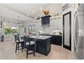 Modern kitchen with dark cabinetry, island, and stainless appliances at 5913 Country Club Dr., Myrtle Beach, SC 29577