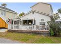 White beach cottage with deck and surrounding homes at 6001 - 1861 S Kings Hwy., Myrtle Beach, SC 29575