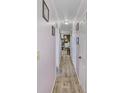 Light and airy hallway with light pink walls and wood flooring at 601 37Th Ave. N # C, Myrtle Beach, SC 29577