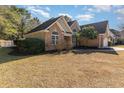 Brick home with a two-car garage and partial side view at 604 Ellis Dr., Conway, SC 29526