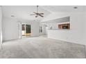 Spacious living room with vaulted ceiling, carpet, and sliding glass doors at 605 West Perry Rd., Myrtle Beach, SC 29579