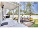 Covered patio with fire pit, seating area, and hot tub at 623 Meadowgrass Ct., Myrtle Beach, SC 29588