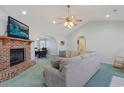 Spacious living room featuring a brick fireplace and vaulted ceiling at 7570 Johnson Rd., Myrtle Beach, SC 29588