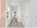 Bright hallway with light walls and wood-look flooring at 842 Cypress Preserve Circle, Longs, SC 29568