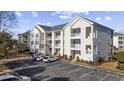 Three-story condo building showcasing tidy exteriors, balconies, and convenient parking spaces for residents and visitors at 901 West Port Dr. # 1706, North Myrtle Beach, SC 29582