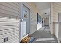 Inviting front door with coastal decor, a welcome mat, and durable outdoor carpet that extends to the units at 901 West Port Dr. # 1706, North Myrtle Beach, SC 29582