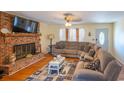 Living room with sectional sofa, brick fireplace, and hardwood floors at 1020 Thomas Ave., North Myrtle Beach, SC 29582