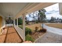 Relaxing front porch view overlooking a large yard and long driveway at 103 Lakeside Dr., Tabor City, NC 28463