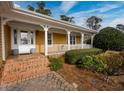 Spacious front porch with brick steps and white columns at 103 Lakeside Dr., Tabor City, NC 28463