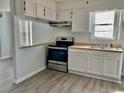 Kitchen with white cabinets, stainless steel appliances, and light countertops at 105 S Merriman Rd., Georgetown, SC 29440