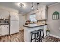 Galley kitchen with white cabinets, tile backsplash, and a breakfast bar at 1100 Naomi Ave., Conway, SC 29526