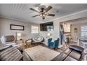 Cozy living room featuring a sectional sofa, armchairs, and a large TV at 1100 Naomi Ave., Conway, SC 29526