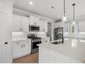 Modern kitchen with stainless appliances, white cabinets and light countertops at 1201 Possum Trot Rd., North Myrtle Beach, SC 29582