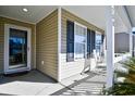 Front porch with rocking chairs and palm tree at 1288 Brighton Ave., Myrtle Beach, SC 29588