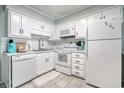 White kitchen with stainless steel appliances and subway tile backsplash at 191 Maison Dr. # B206, Myrtle Beach, SC 29572