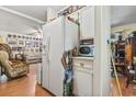 Kitchen with white appliances and view into living room at 2102 Calabash Circle, Little River, SC 29566