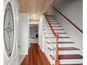 Bright entryway with hardwood floors and a staircase leading upstairs at 2102 S Ocean Blvd. # D, North Myrtle Beach, SC 29582