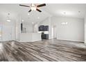 Open-concept living space with vinyl plank flooring and high ceilings at 245 Six Mile Creek Dr., Georgetown, SC 29440