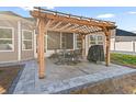 Relaxing backyard patio with pergola, seating area, and grill at 3047 Honey Clover Ct., Longs, SC 29568