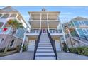 Curved staircase leading to the entrance of a charming three-story home at 369 Saint Julian Ln., Myrtle Beach, SC 29579