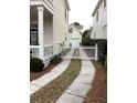 Curved driveway with white gate leading to garage at 41 Federation Loop, Pawleys Island, SC 29585