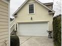 Attached garage with white door and exterior stairs at 41 Federation Loop, Pawleys Island, SC 29585