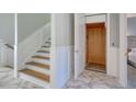 Elegant staircase with wood steps and white railings next to an elevator at 4208 N Ocean Blvd., North Myrtle Beach, SC 29582