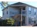 Gray building with a wooden staircase and multiple windows at 423 Tree Top Ct. # 23-D, Myrtle Beach, SC 29588