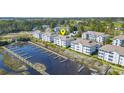 Community aerial view shows docks, water access, and multiple buildings at 4413 Eastport Blvd. # F-6, Little River, SC 29566