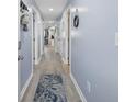 Light blue hallway with wood-look floors and access to other rooms at 4524 N Plantation Dr. # D9, Little River, SC 29566