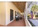 Relaxing front porch with white columns and American flag at 4705 Harness Ln., Murrells Inlet, SC 29576