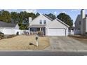 Two-story house with a white garage door and front porch at 4821 Southgate Pkwy., Myrtle Beach, SC 29579