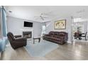 Comfortable living room features a fireplace, plush leather seating, and hardwood floors at 4821 Southgate Pkwy., Myrtle Beach, SC 29579