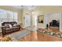 Living room with hardwood floors, a couch, and access to office and entryway at 541 Sand Ridge Rd., Conway, SC 29526