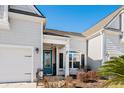 Inviting front entrance with teal door and landscaping at 5522 Elba Way # 5522, Myrtle Beach, SC 29579