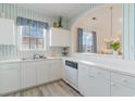 White kitchen with appliances, ample counter space, and striped wallpaper at 5751 Oyster Catcher Dr. # 931, North Myrtle Beach, SC 29582