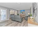 Bright living room with gray sofas, large TV, and plenty of natural light at 6001-1027 S Kings Hwy., Myrtle Beach, SC 29575