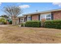 Front view of brick ranch house with well-maintained lawn at 676 Pelican Ave. # 676, Myrtle Beach, SC 29577