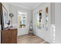 Light-filled entryway with white door and wood flooring at 744 Crystal Water Way, Myrtle Beach, SC 29579