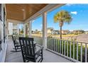 Relaxing front porch with rocking chairs overlooking the neighborhood at 744 Crystal Water Way, Myrtle Beach, SC 29579