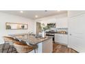 Kitchen island with granite countertops and wicker barstools at 809 Green Garden Way, Myrtle Beach, SC 29579