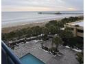 Aerial view of oceanfront pool and grounds with palm trees at 8560 Queensway Blvd. # 304, Myrtle Beach, SC 29572