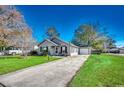 House's exterior showcases a landscaped yard and attached garage at 9431 Leeds Circle, Myrtle Beach, SC 29588