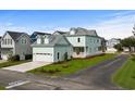 Two-story light green house with a detached garage and landscaped yard at 946 Crystal Water Way, Myrtle Beach, SC 29579