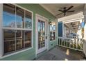 Front porch with white door and ceiling fan at 111 Addison Cottage Way, Murrells Inlet, SC 29576