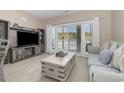 Living room with grey couch and view of balcony overlooking snow covered landscape at 112 Cypress Point Ct. # 202, Myrtle Beach, SC 29579