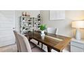 Dining area with wood table, chairs, and built-in shelving at 1124 Blueback Herring Way # 158, Conway, SC 29526