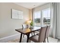 Cozy dining area with wood table, four chairs, and large windows at 1124 Blueback Herring Way # 158, Conway, SC 29526